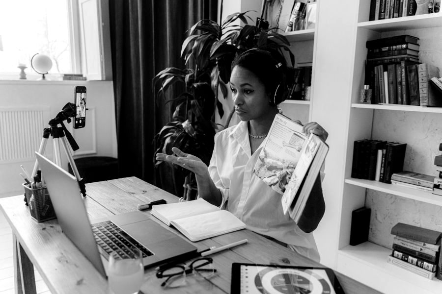 Educator recording an online class with a laptop and camera