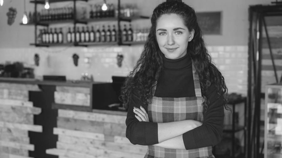 Small business owner standing proudly in her shop